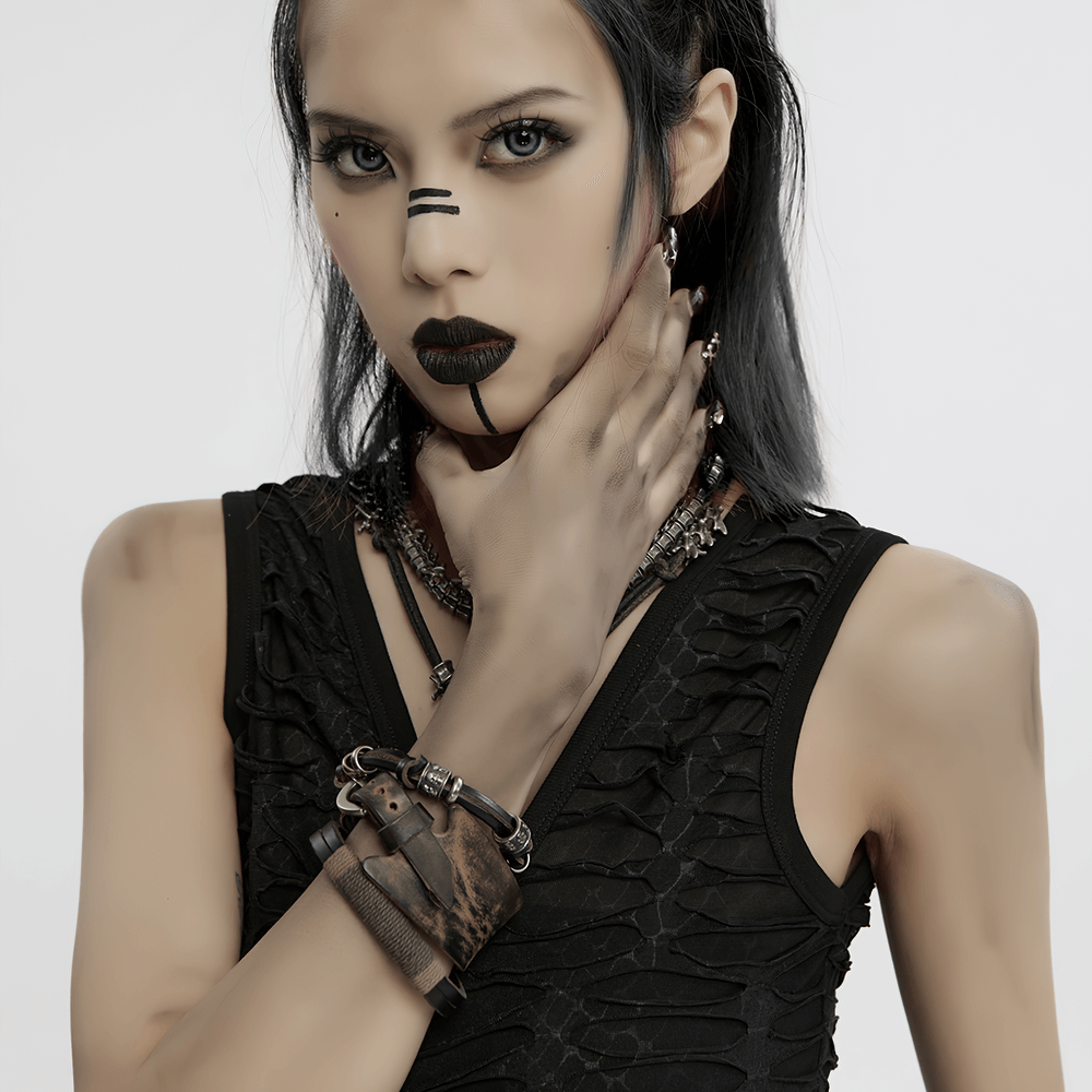 Model showcasing a vintage leather punk bracelet set with skull beads and fierce punk style makeup.