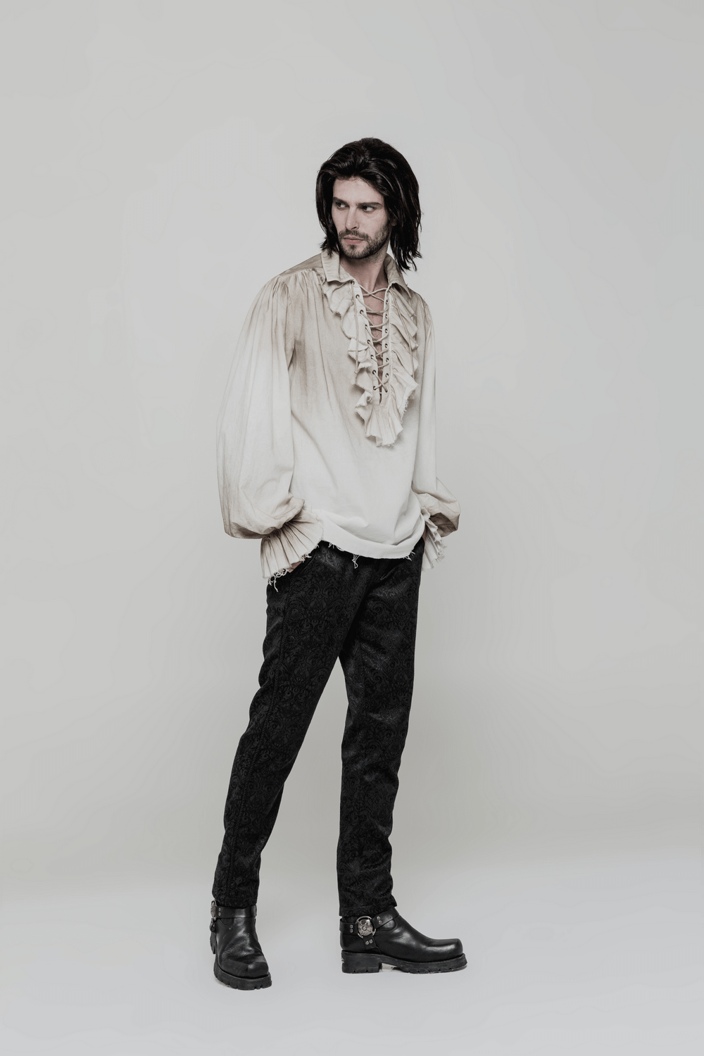 Model wearing a vintage linen pirate shirt with eyelet lace-up front and black pants, showcasing a retro steampunk style.