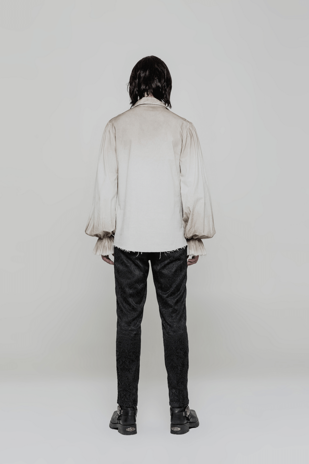 Back view of a model wearing a vintage linen pirate shirt with eyelet lace-up and loose fit.
