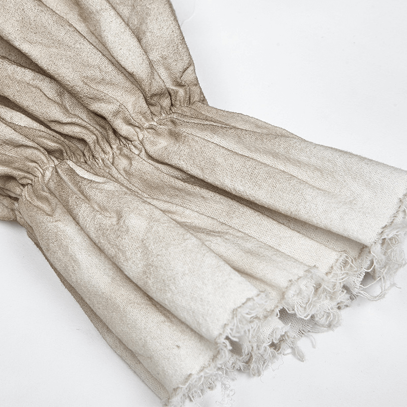 Close-up of the frayed cuffs of a vintage linen pirate shirt, showcasing the retro design and texture.