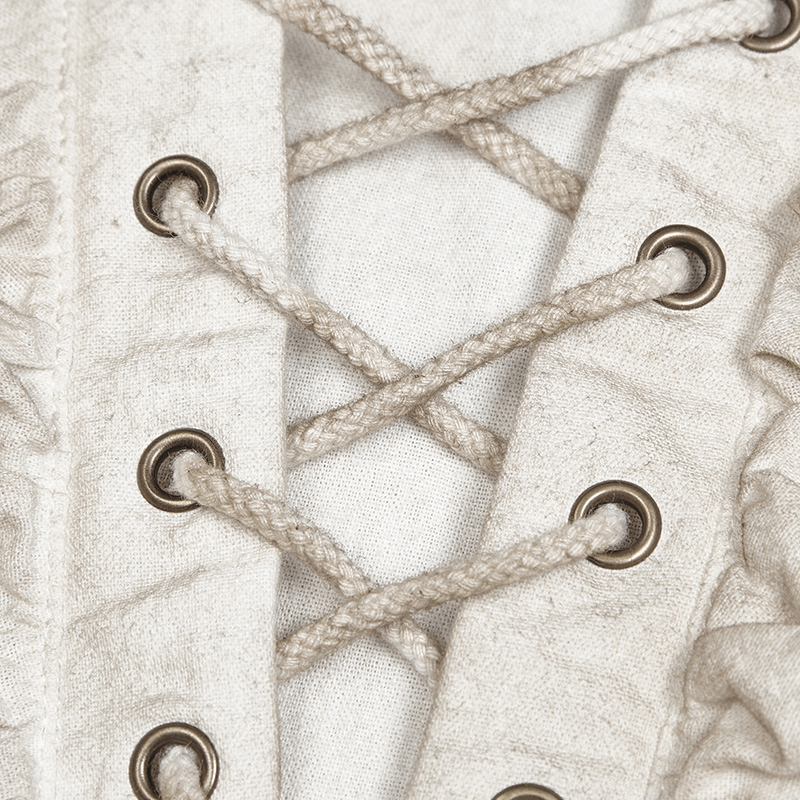 Close-up of the eyelet lace-up front of a vintage linen pirate shirt with drawstring details.