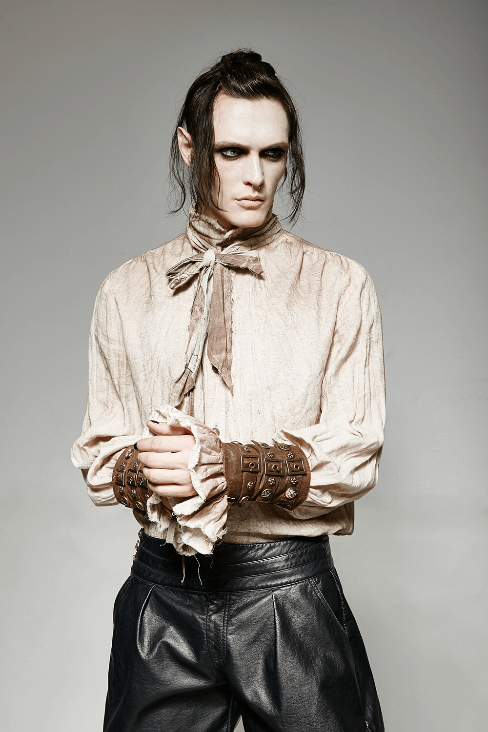 Stylish model wearing a vintage linen retro steampunk tie shirt with unique cuffs and a distinct collar design.