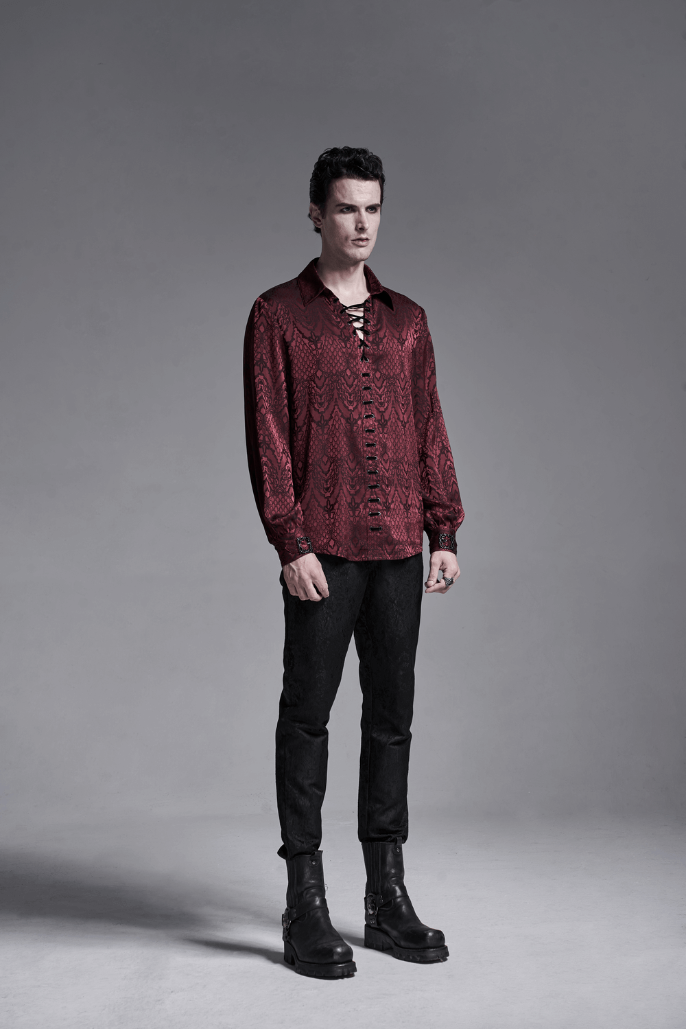 Stylish man wearing a vintage lace-up gothic shirt in dark red jacquard fabric, showcasing an elegant retro design.
