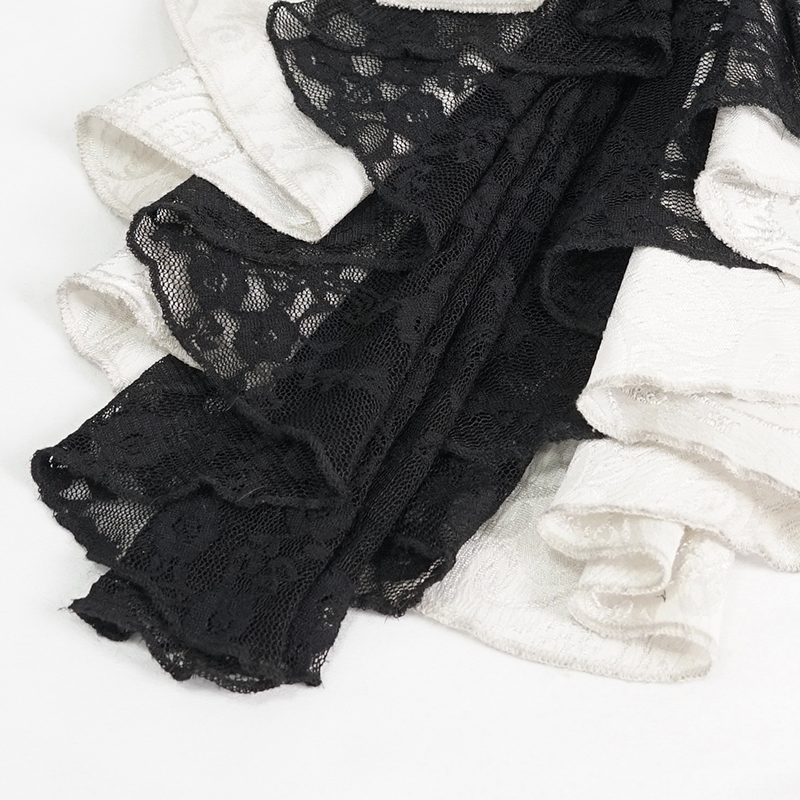 Close-up of black and white frilly lace, showcasing vintage tie details and elegant textures.