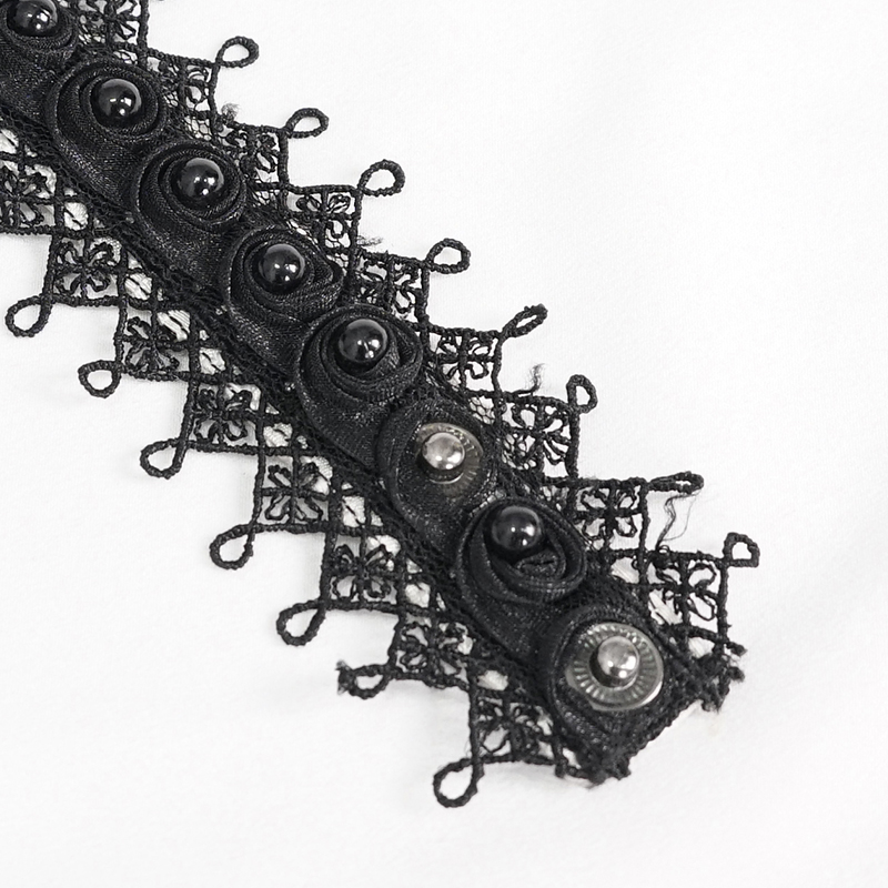 Close-up of vintage black lace trim featuring decorative buttons, perfect for enhancing elegant attire.