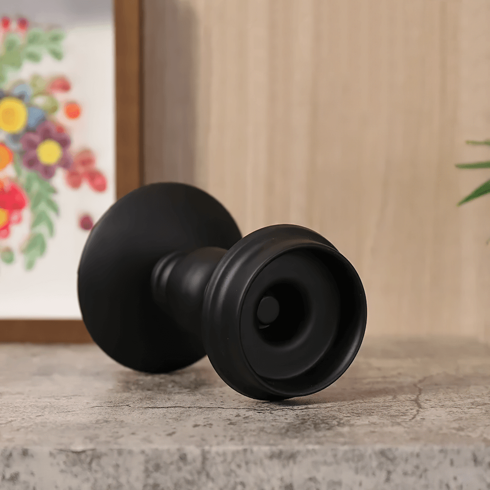 Vintage matte black Nordic iron candle holder on a concrete surface, ideal for modern and gothic decor.