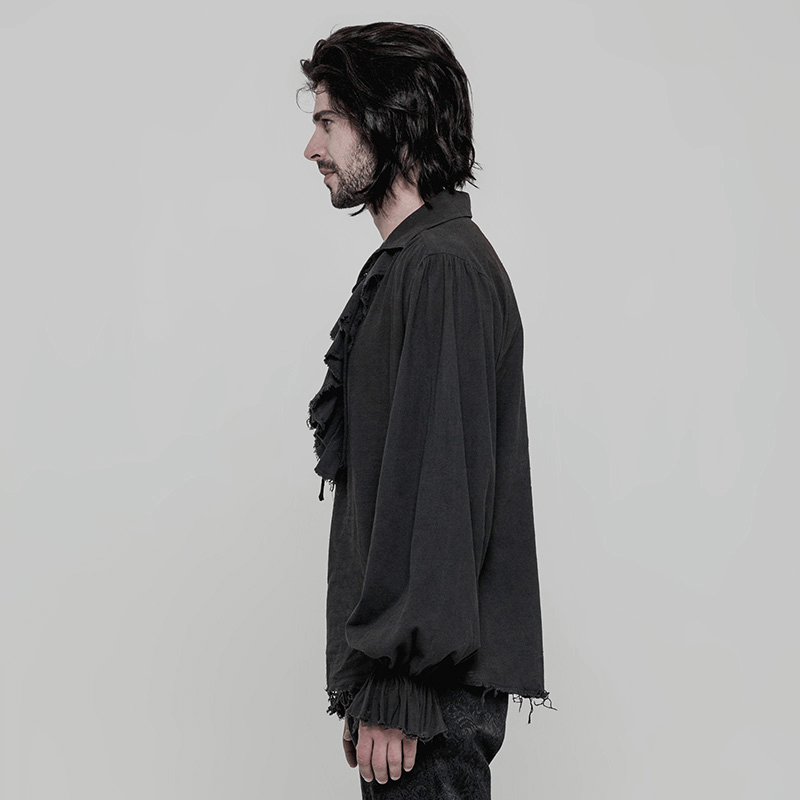 Side view of a man in a vintage black long sleeve Gothic shirt with ruffle front and distressed cuffs.