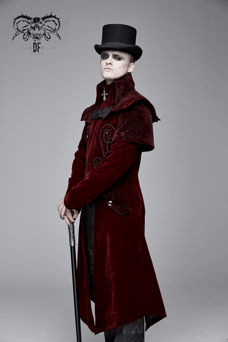 Stylish man in a vintage wine red velvet gothic coat with a high collar and top hat, holding a cane.