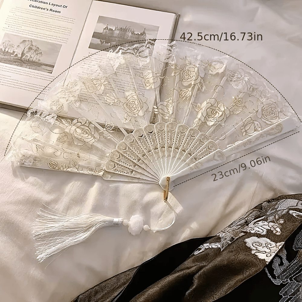 Vintage Rose Lace Folding Fan with Tassel Pendant on a soft surface, showcasing its elegant design and measurements.