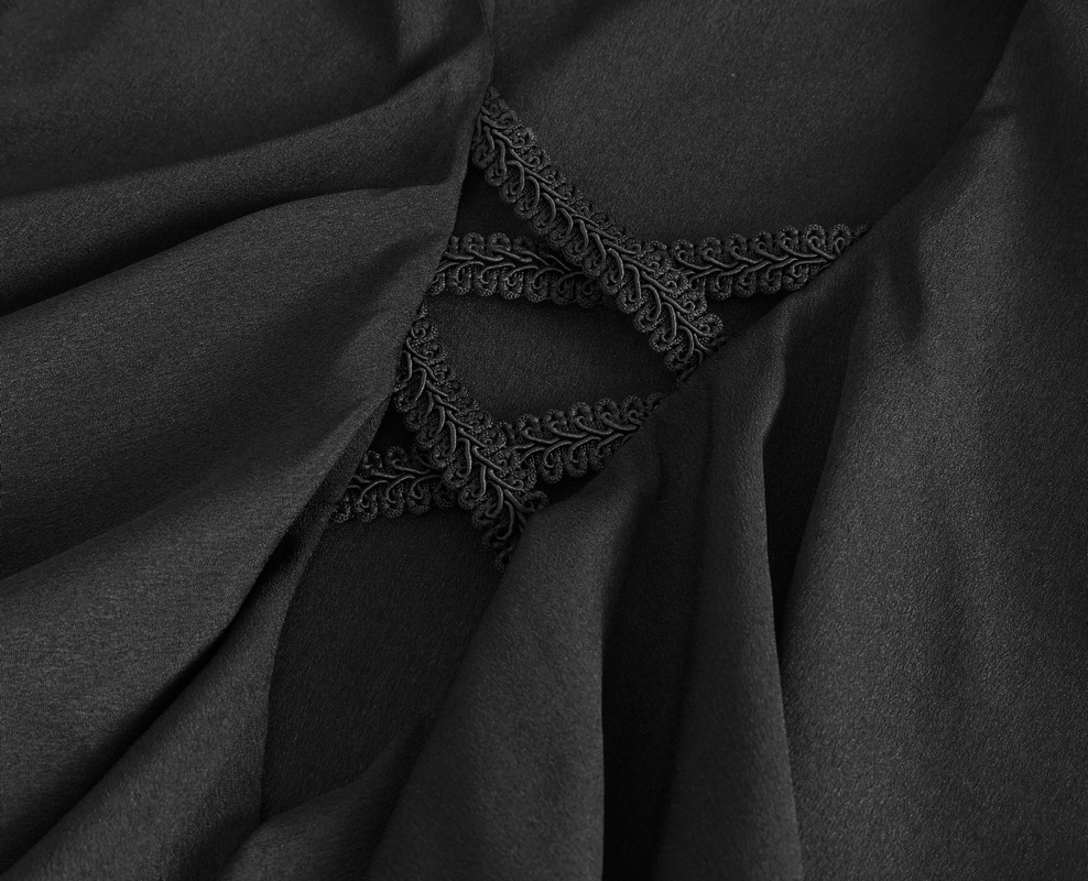 Close-up of ruffled black fabric with intricate lace detail, showcasing vintage-style elegance and modern flair.