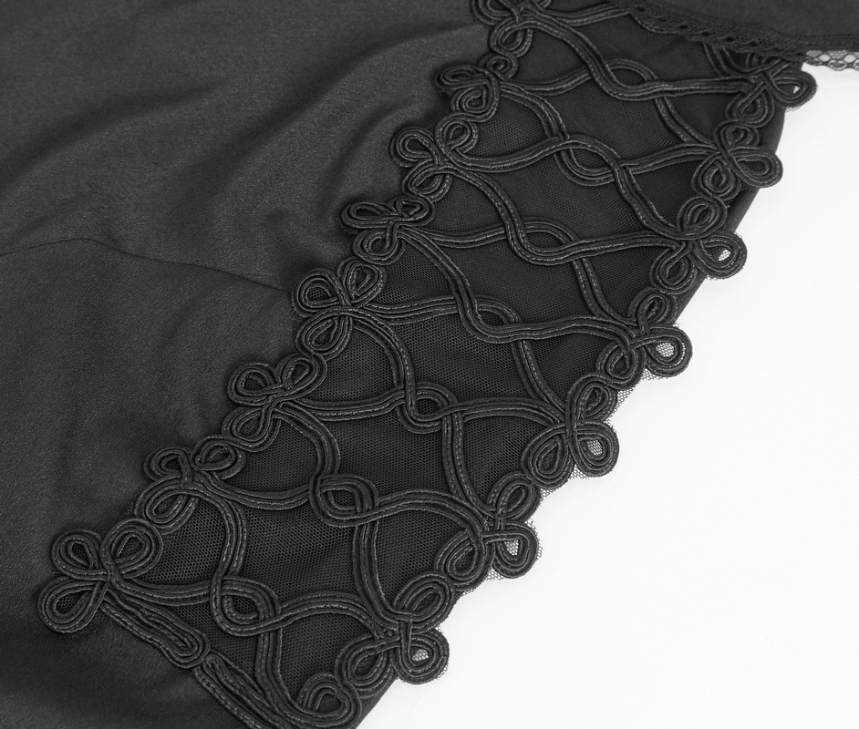 Close-up of black fabric featuring intricate looped embroidery with ruffled edge detail for a vintage-style shirt.