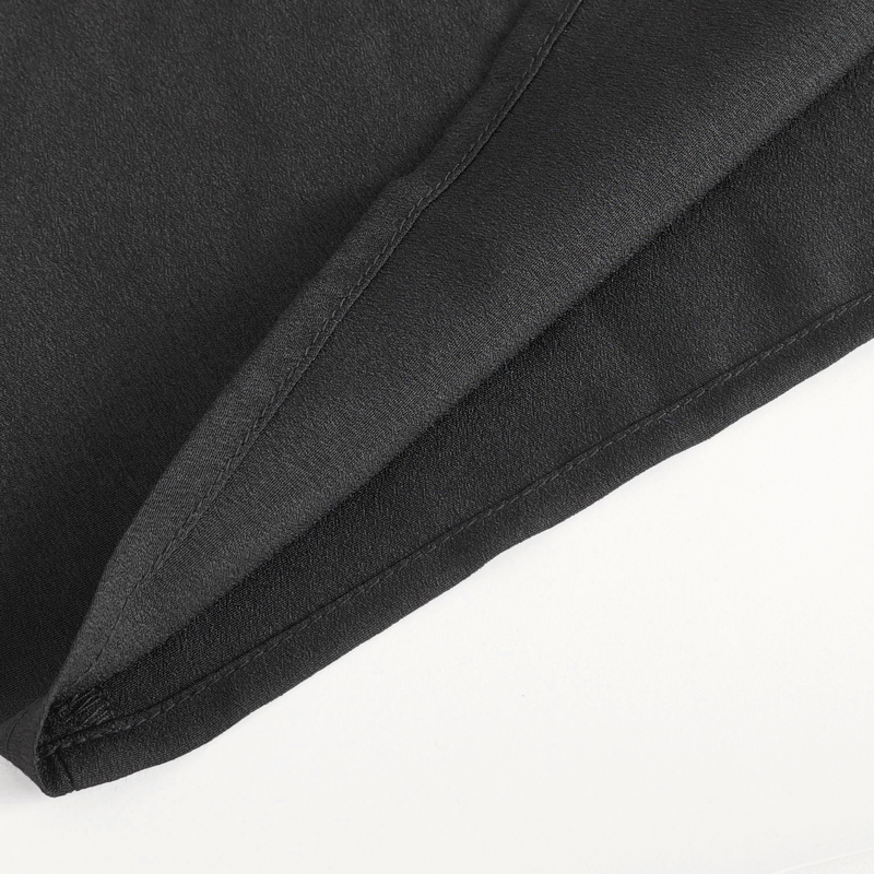 Close-up of the fabric and hem detail of a vintage ruffle sleeves shirt in elegant black.