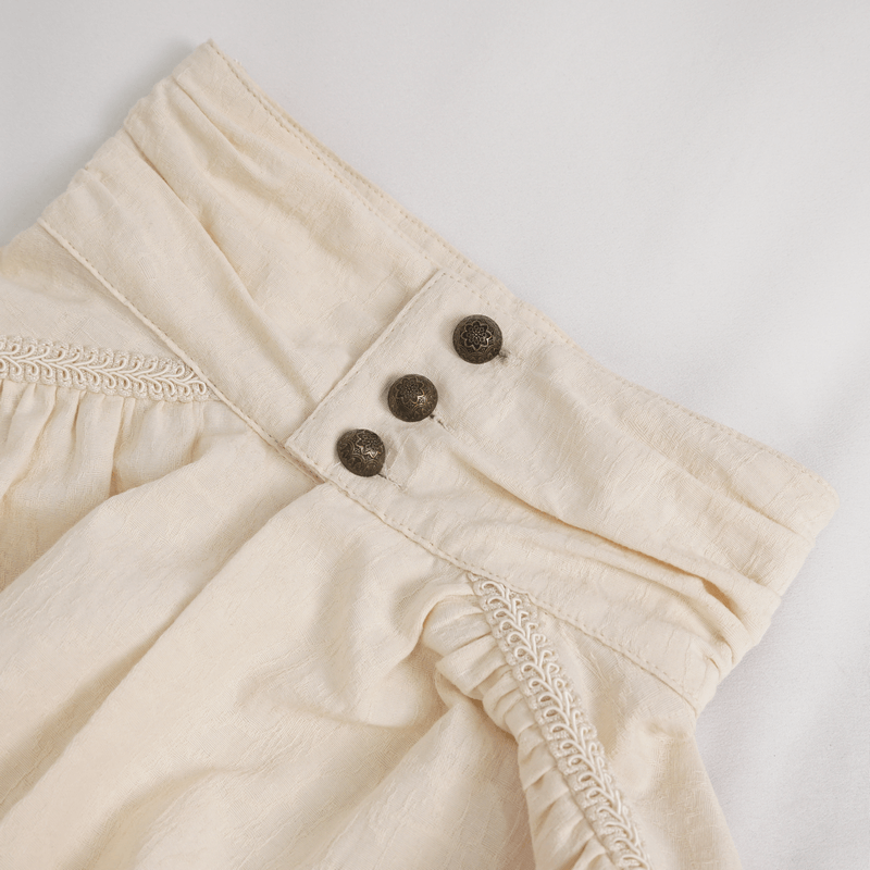 Close-up of vintage cream cotton shirt showcasing stylish buttons and elegant detailing, perfect for classic fashion lovers.