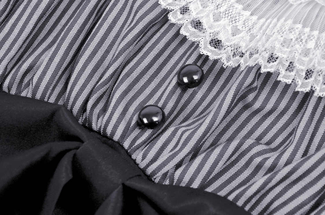 Close-up of vintage striped dress featuring lace collar, elegant bow, and decorative buttons.