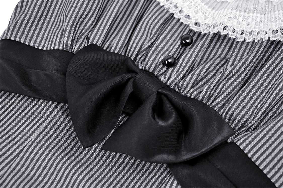 Close-up of vintage striped dress featuring a lace collar, bow detail, and classic pinstripes for a feminine touch.