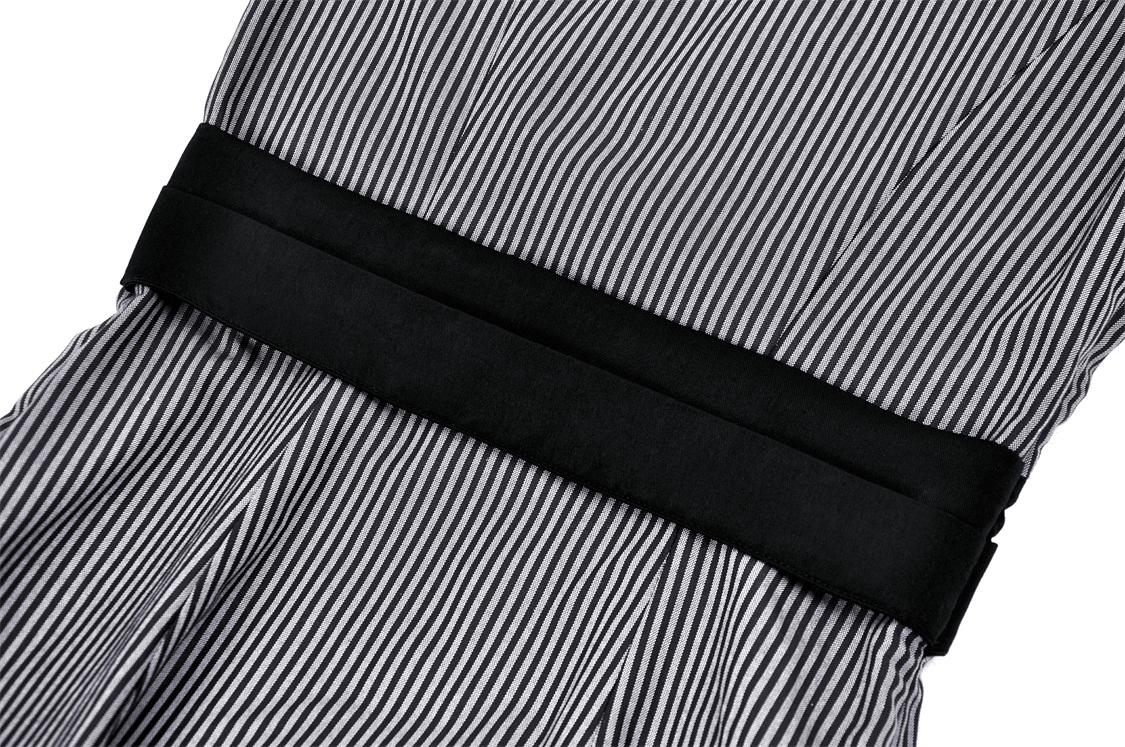 Close-up of vintage striped dress featuring a black bow detail and elegant pinstripes for a classic look.