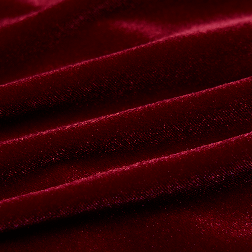 Luxurious red velvet fabric with an elegant, soft texture, perfect for vintage-inspired dresses.