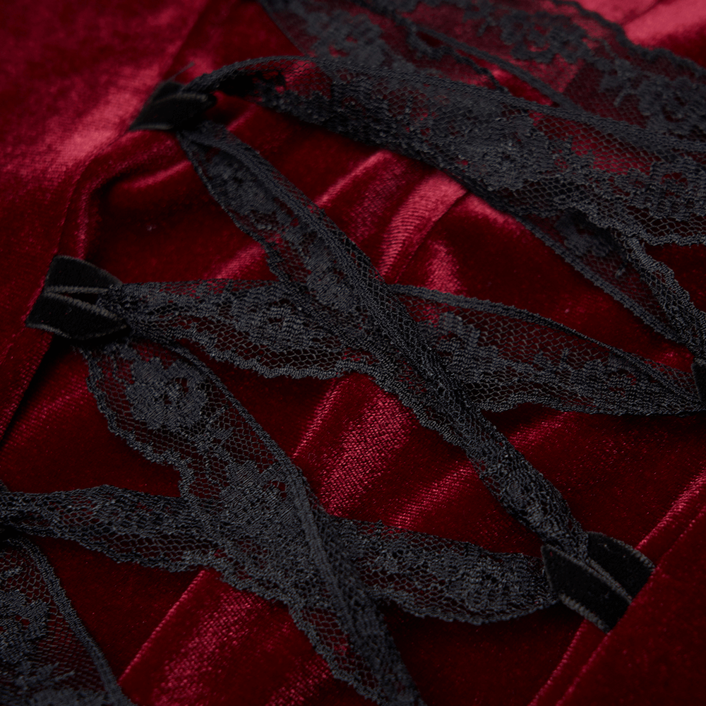 Close-up of lace detail on a vintage red velvet dress, showcasing gothic elegance and intricate texture.
