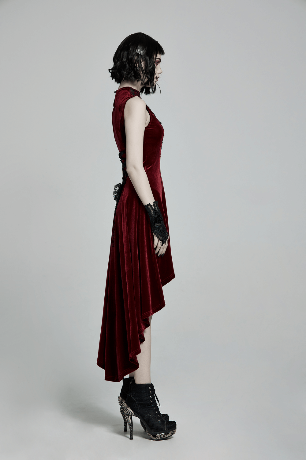 Vintage red velvet high-low dress with lace detail, showcasing a gothic style in a figure-hugging silhouette.