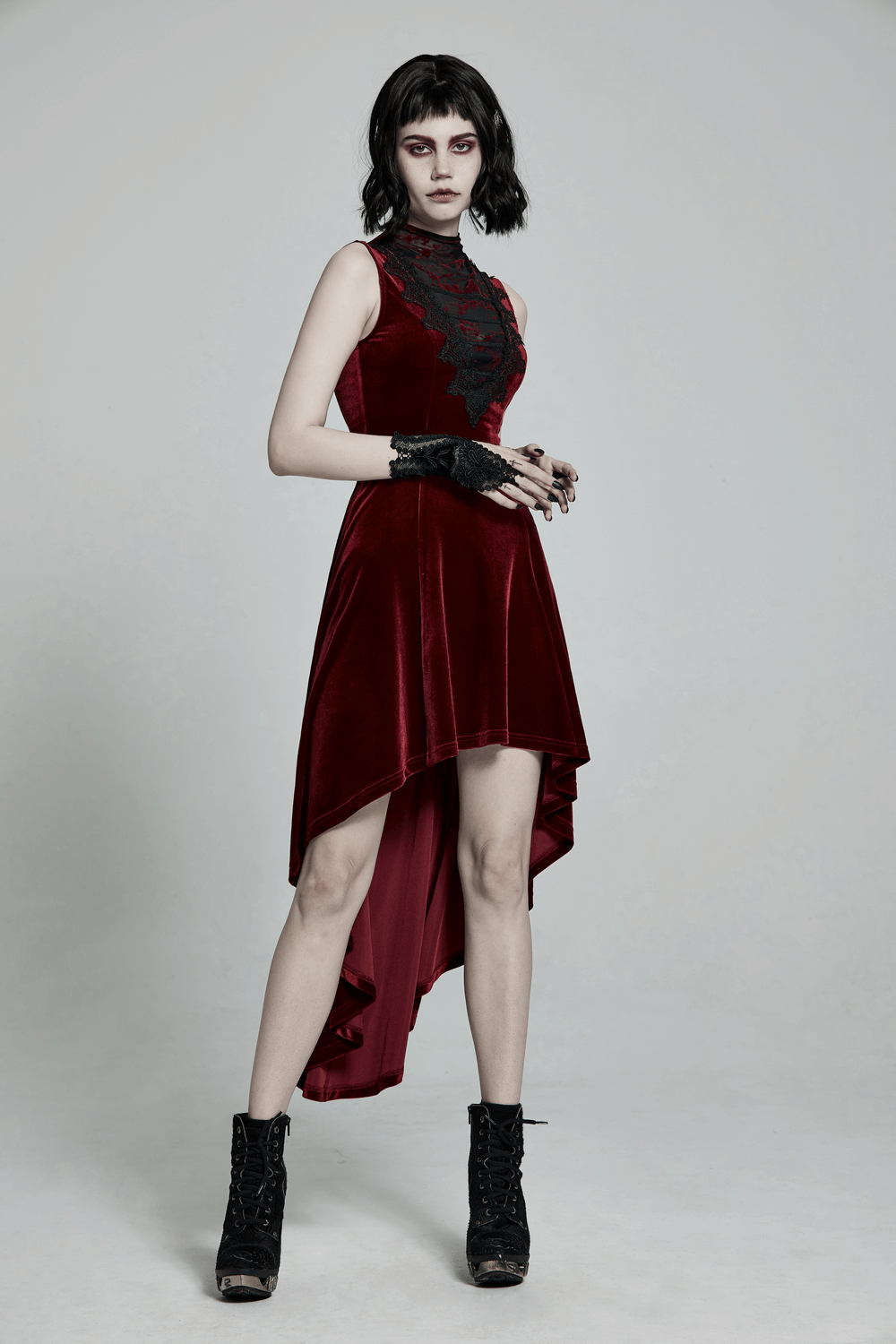 Vintage-style red velvet high-low dress with lace detail, showcasing gothic elegance and a figure-hugging silhouette.