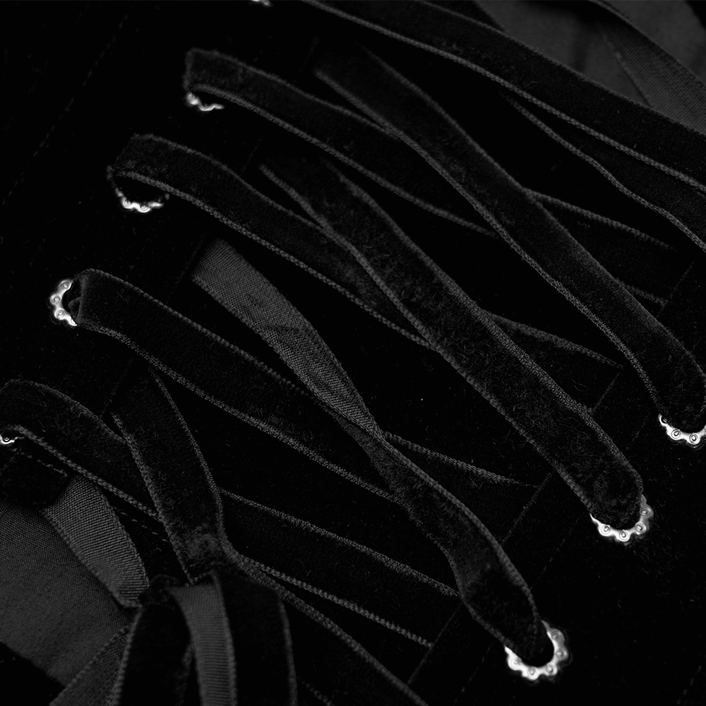 Close-up of vintage velvet cincher with lace-up details, showcasing intricate design and elegant craftsmanship.