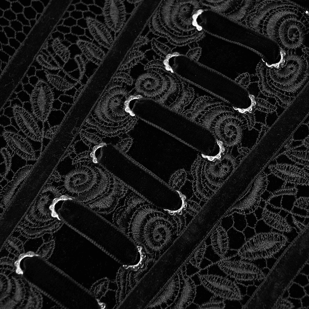 Close-up of vintage velvet cincher with intricate rose lace and decorative eyelets showcasing Gothic elegance.