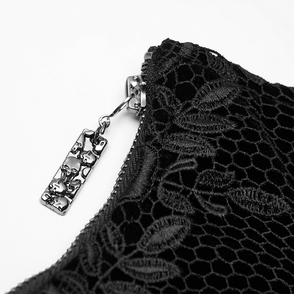 Close-up of the vintage velvet cincher zipper featuring a decorative skull pendant and intricate rose lace design.