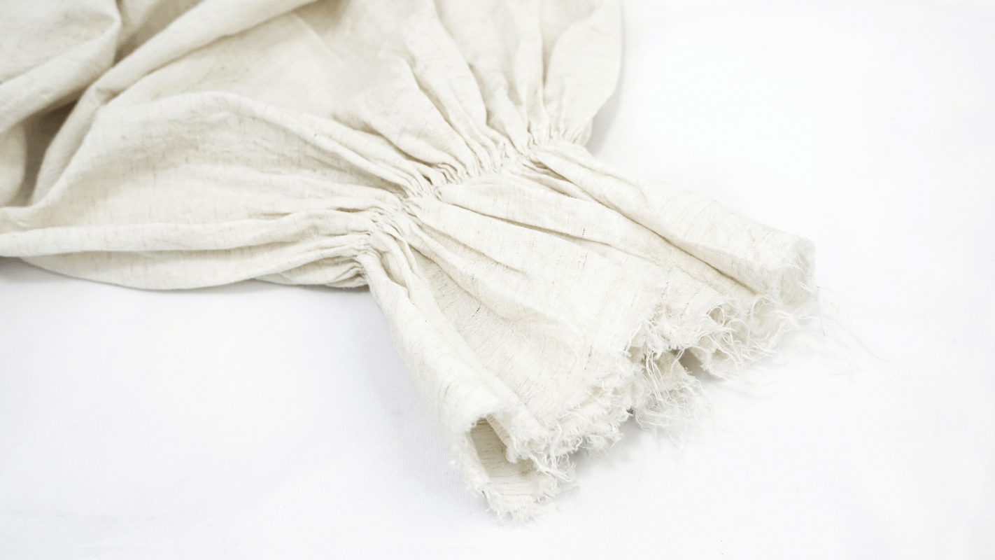 Close-up of the flared cuff detail on a vintage white gothic men's shirt with ruffles.