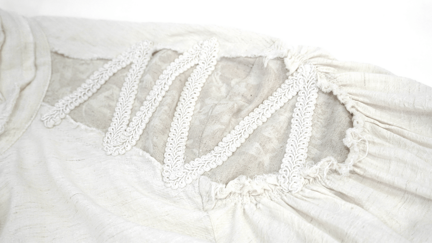 Close-up of ruffled white fabric featuring lace detailing on a gothic vintage men's shirt.