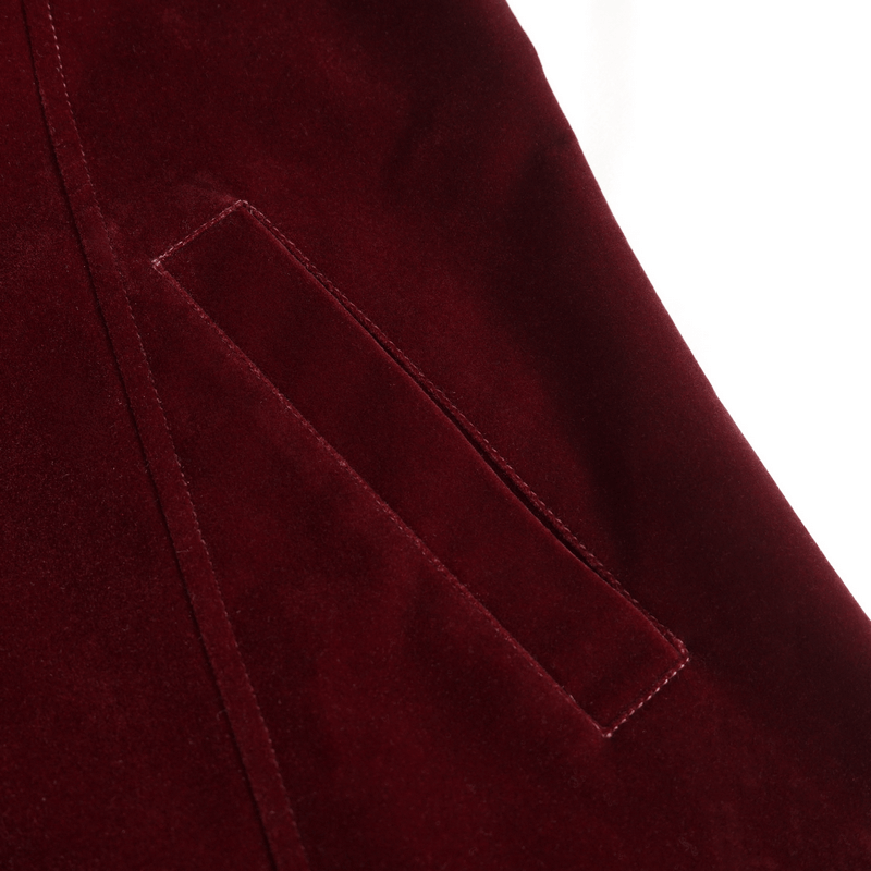 Close-up of wine red fabric featuring a sleek pocket design on a vintage-style coat.