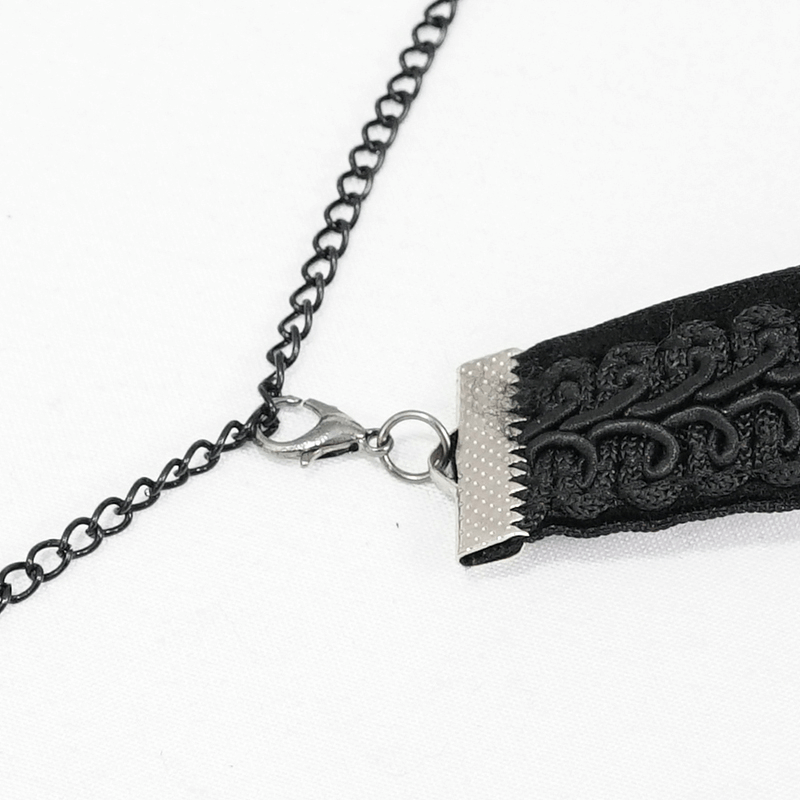 Close-up of a vintage black choker with chains and intricate design, perfect for gothic style accessories.