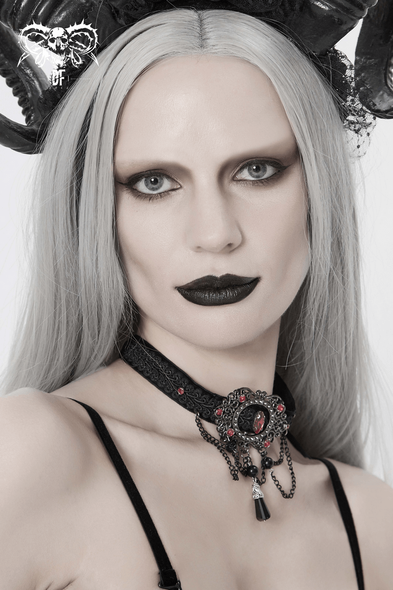 Elegant gothic-style women's choker with chains and blood-red stones, worn by a model with striking makeup.