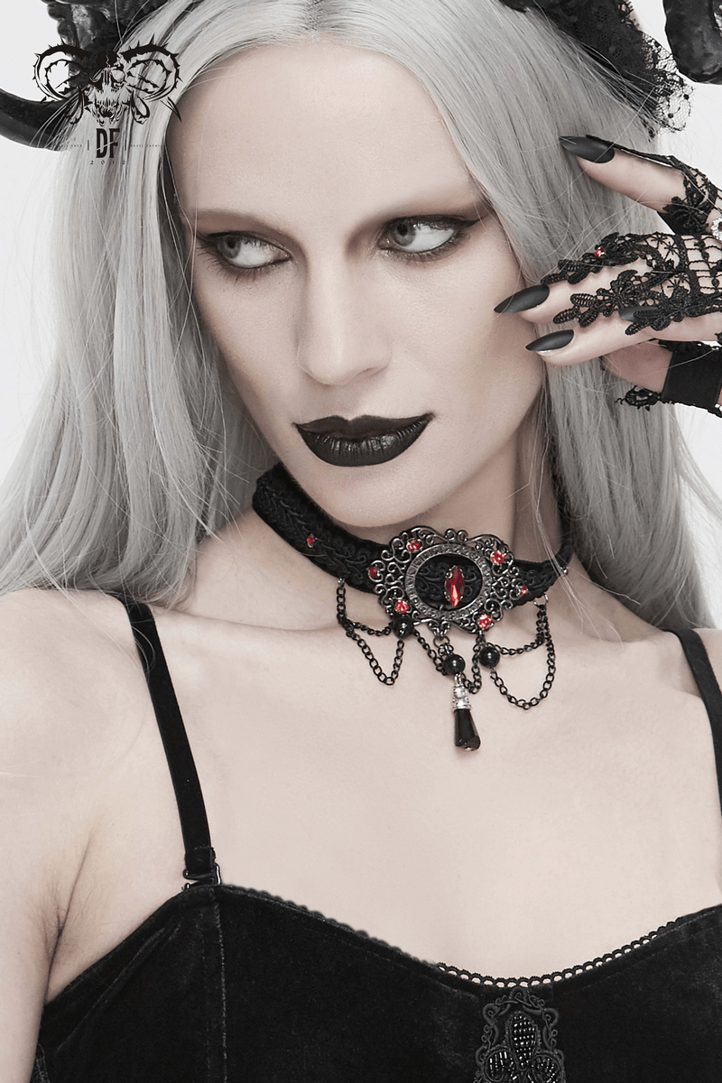 Elegant gothic choker with chains and blood-red stones worn by model with gray hair and dramatic makeup.
