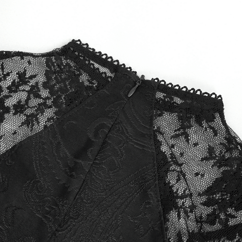 Close-up of vintage women's lace dress detailing with intricate lace applique and elegant beading.