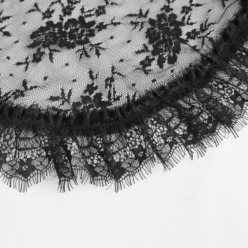 Close-up of intricate black lace fabric with delicate floral patterns and scalloped edges, perfect for vintage dresses.