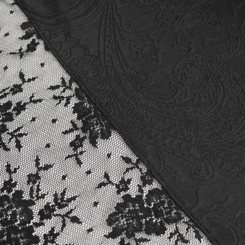 Close-up of intricate black lace patterns on vintage dress fabric, showcasing delicate designs and textures.