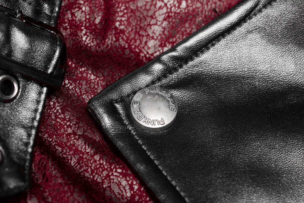 Close-up of vintage women's leather punk jacket detail with contrasting rubber sleeves and metal button.