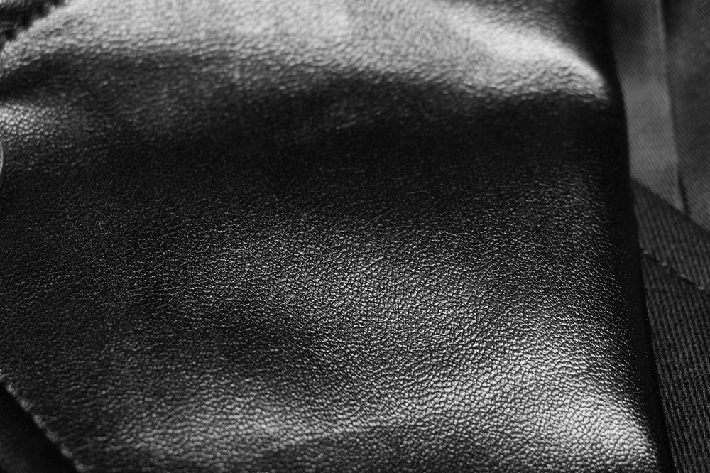 Close-up of textured black leather showcasing its rich, durable style perfect for vintage punk jackets.
