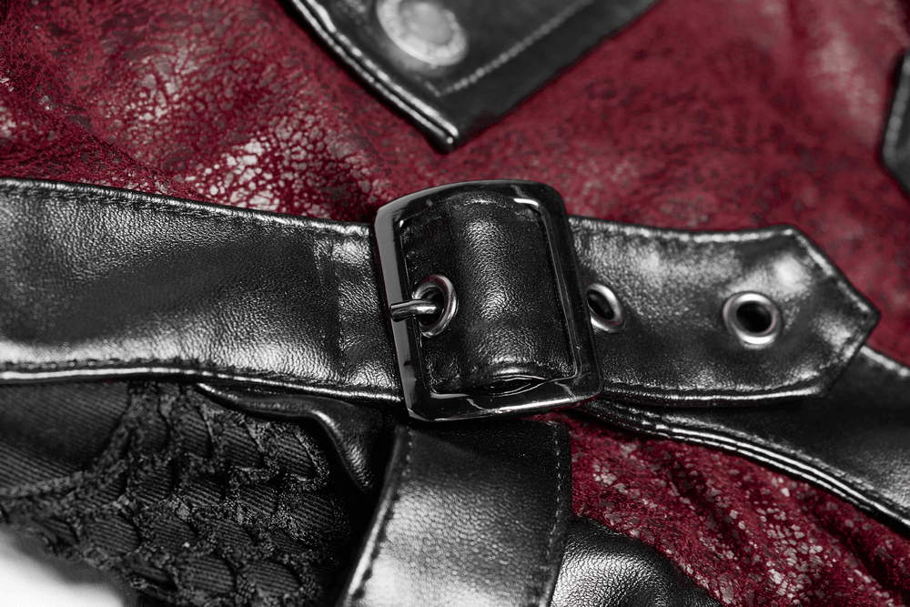 Close-up of adjustable strap on a vintage red leather punk jacket with rubber sleeves.