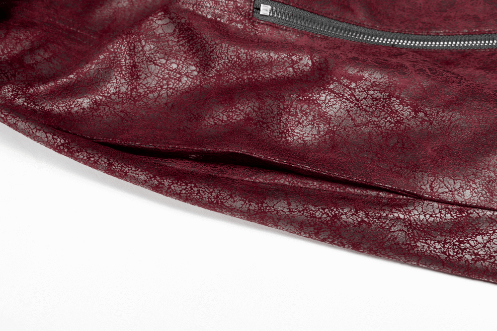 Close-up of vintage red leather punk jacket showcasing unique textured fabric and zipper detail.