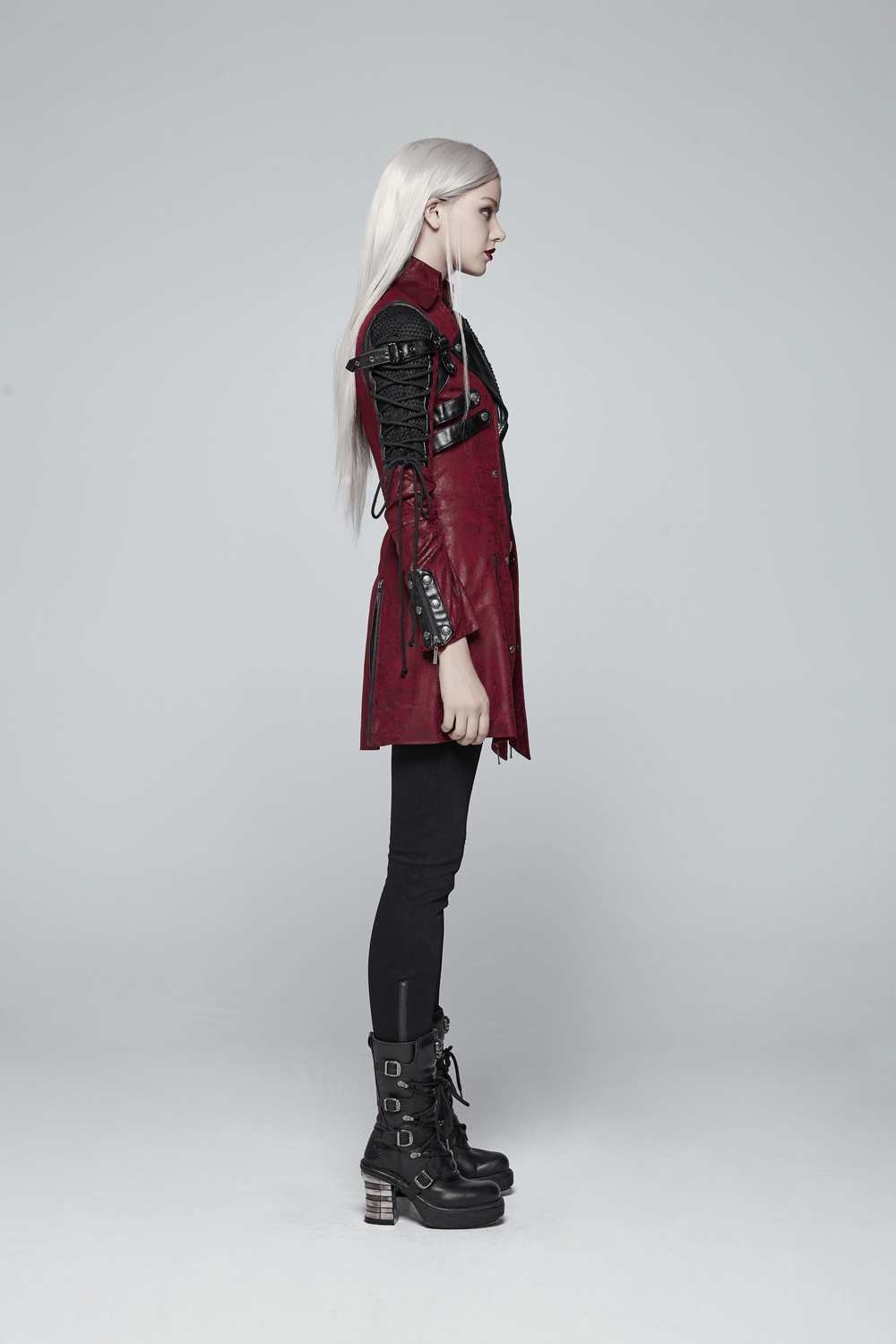 Side view of vintage women's leather punk jacket with rubber sleeves and adjustable straps, showcasing a bold gothic style.