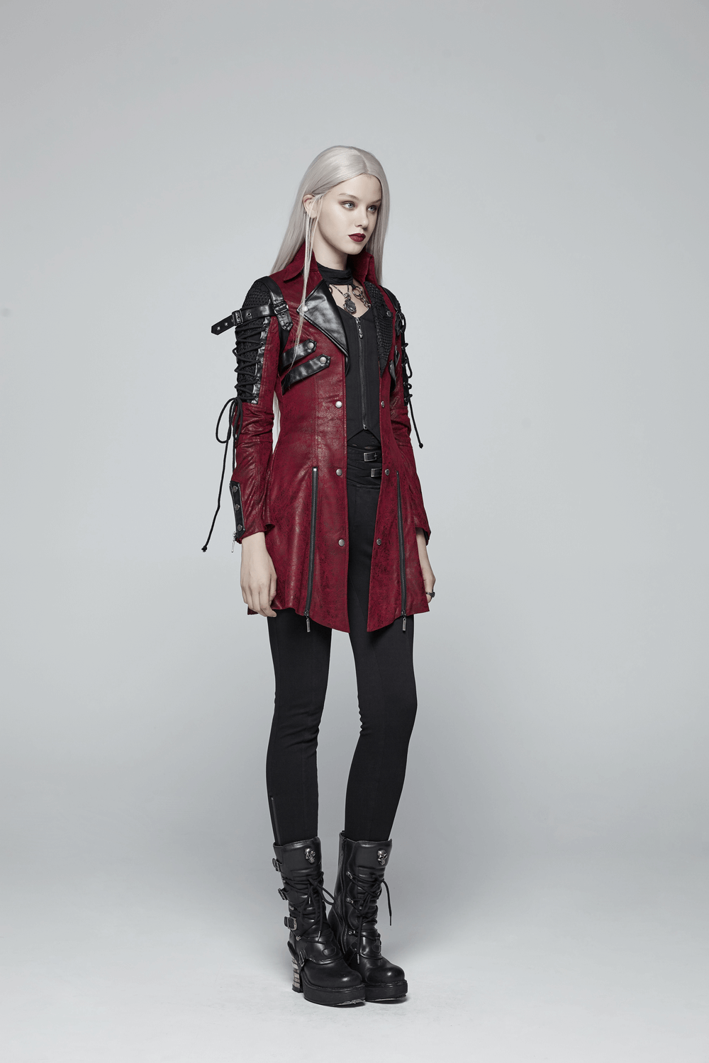 Vintage women's red leather punk jacket with straps and rubber sleeves, perfect for a bold gothic look.