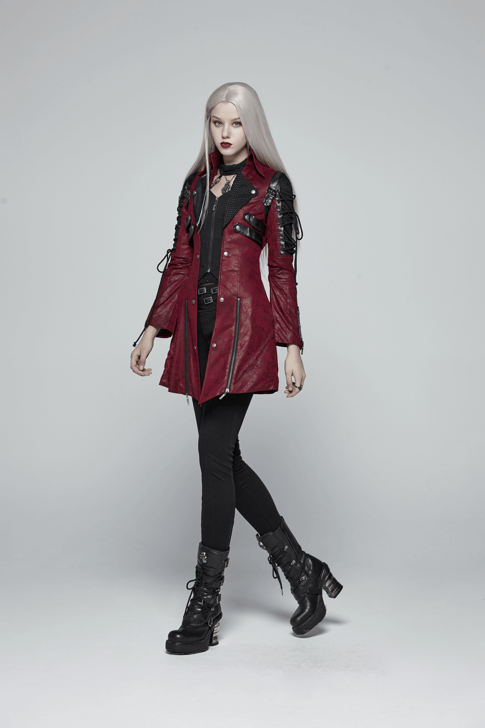 Vintage red leather punk jacket with straps and rubber sleeves, showcasing edgy gothic style.