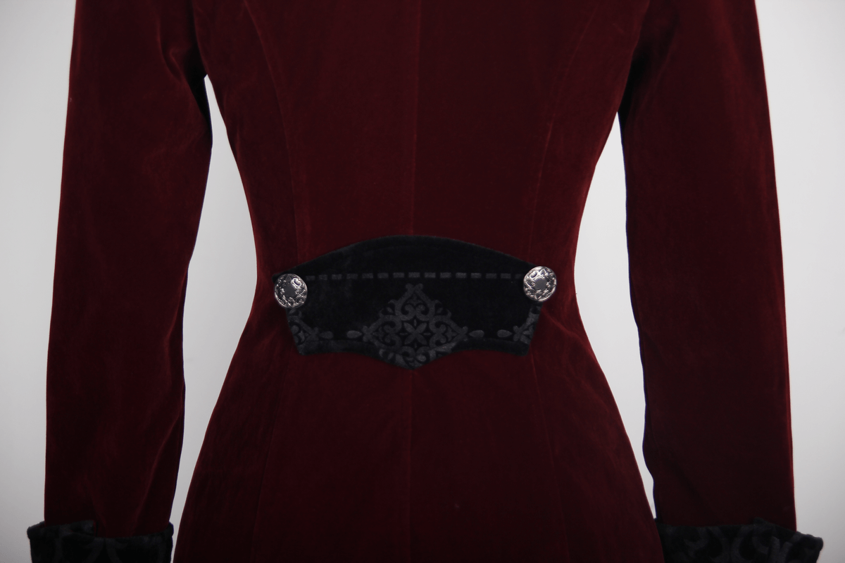Close-up of the fitted back of a vintage women's gothic burgundy velvet coat with elegant embroidery and buttons.