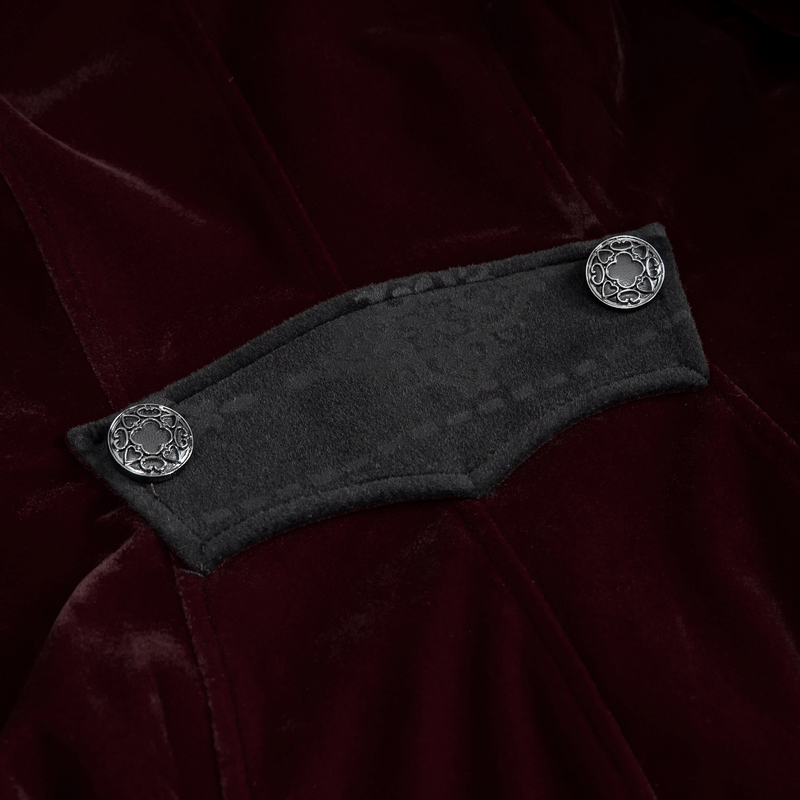 Close-up of vintage women's burgundy velvet coat detailing with ornate silver buttons and a unique fabric panel.