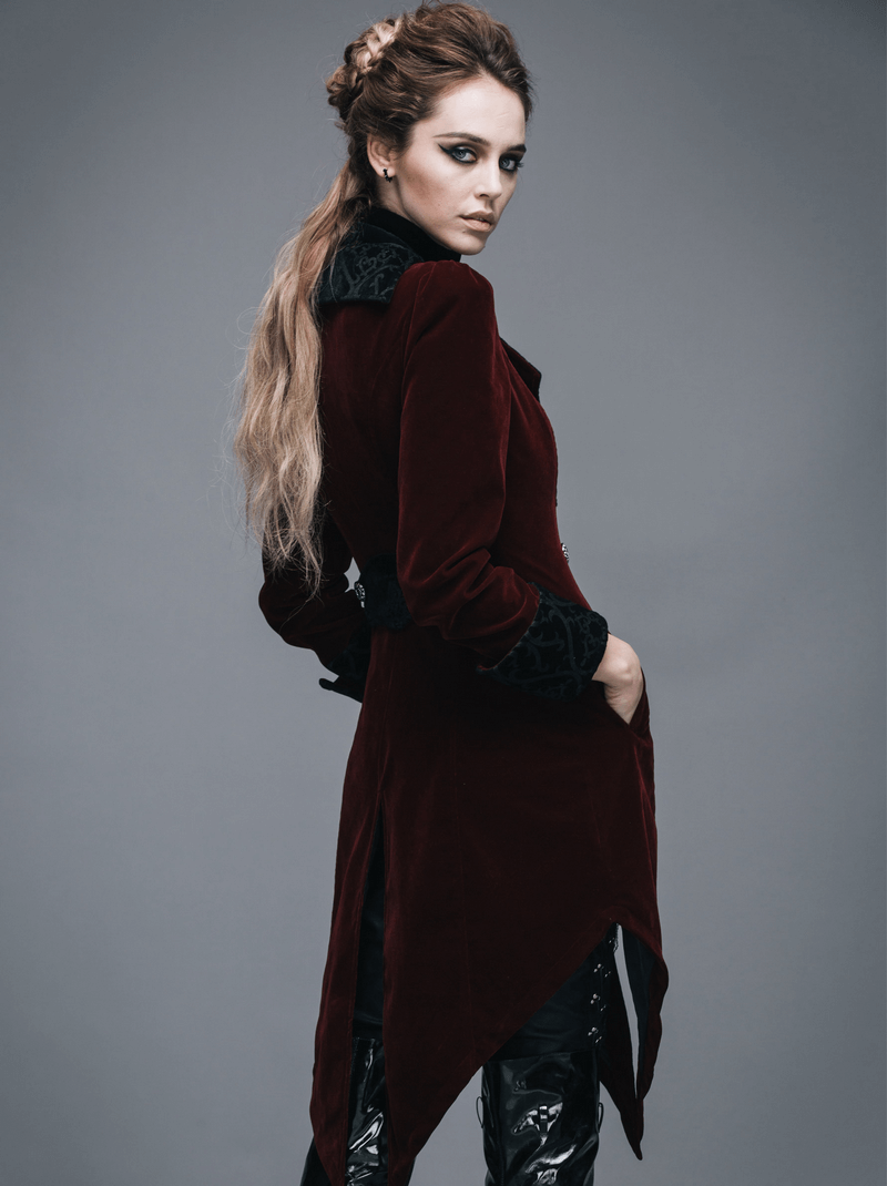 Stylish woman in a vintage burgundy velvet steampunk coat showcasing gothic elegance.