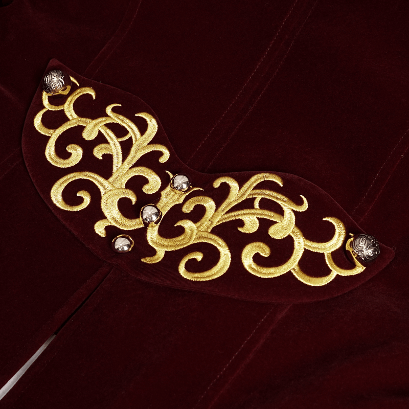 Close-up of gold embroidery on wine red tailcoat, showcasing intricate gothic patterns and elegant details.