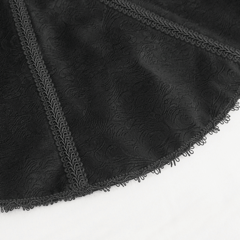 Close-up of intricate black fabric featuring a textured design and elegant lace trim, ideal for gothic and vintage clothing.