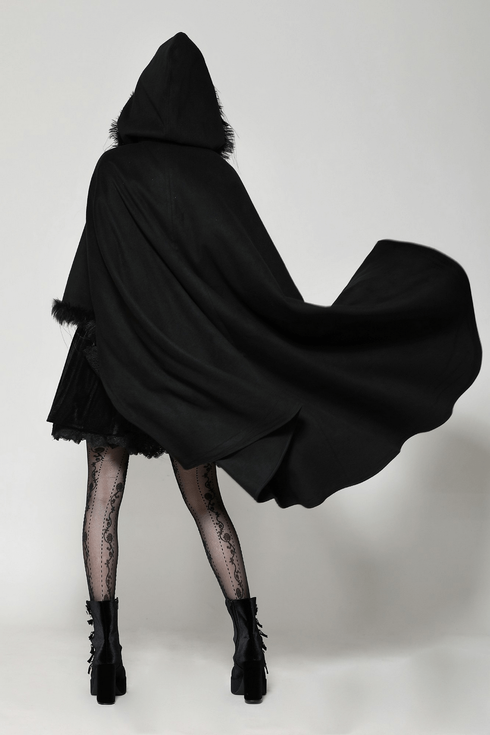 Elegant black hooded cape with faux fur trim, flowing dramatically, ideal for gothic style and cosplay.