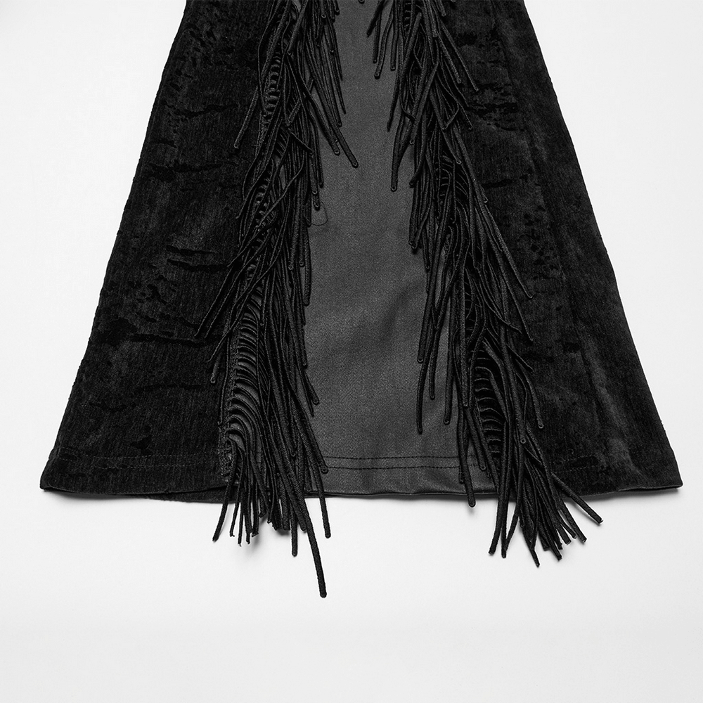 Close-up of black tassel flare pants with velvet detailing, showcasing dynamic tassels and unique fabric splicing.